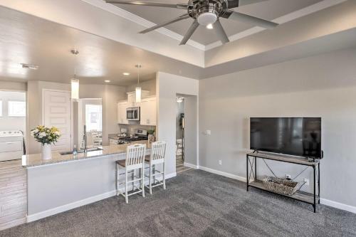 a kitchen and living room with a flat screen tv at Idyllic Kingman Retreat with Yard - Near Hiking in Kingman