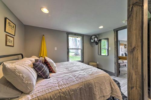 a bedroom with a bed and a large window at The Reubling House - Modern-Rustic Cabin! in Defiance