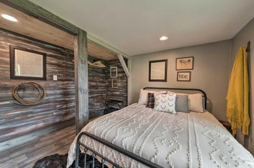 a bedroom with a bed and a wooden wall at The Reubling House - Modern-Rustic Cabin! in Defiance