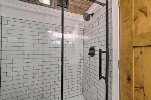 a shower with a glass door in a bathroom at The Reubling House - Modern-Rustic Cabin! in Defiance