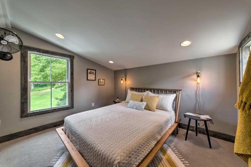 a bedroom with a large bed and a window at The Reubling House - Modern-Rustic Cabin! in Defiance