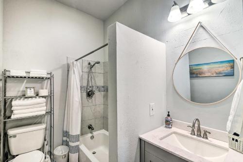 a bathroom with a sink and a toilet and a mirror at about 1 Mi to Pier and Beaches! Family Home in Galveston in Galveston