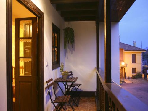 a porch with chairs and a table on a balcony at El Requexu, apartamentos a 900 m de la playa de Poo AR-0474-AS in Llanes