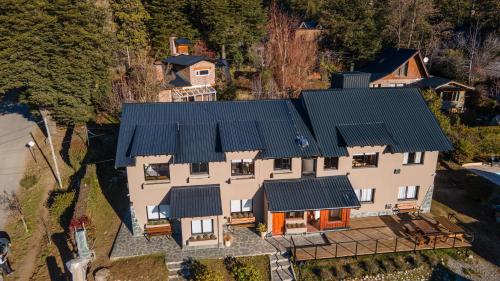 an aerial view of a house with a green roof at Complejo Quillaipe Apart Suite in San Carlos de Bariloche