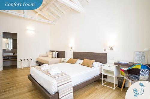 Postel nebo postele na pokoji v ubytování Karú Suites