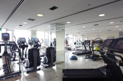 a gym with many treadmills and elliptical machines at ANA Crowne Plaza Kobe by IHG in Kobe