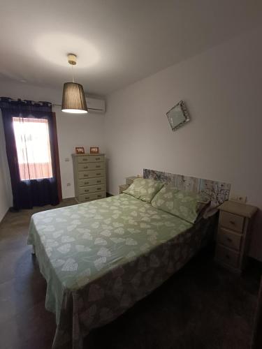 a bedroom with a bed and a dresser and a window at FIGONERO 4-6 in Las Peñas de Riglos