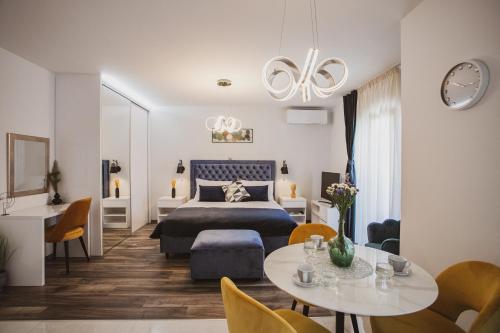 a bedroom with a bed and a table and chairs at Luxury house Lucija in Dugi Rat
