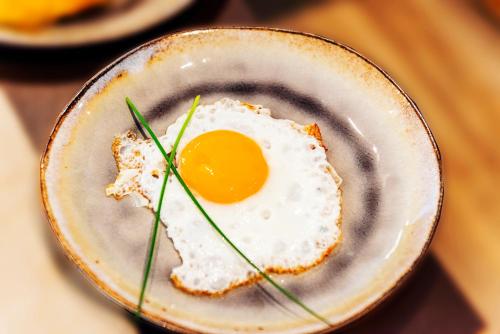 a fried egg in a bowl on a table at Hochjochstöbli B&B Alpine Easy Stay in Schruns-Tschagguns