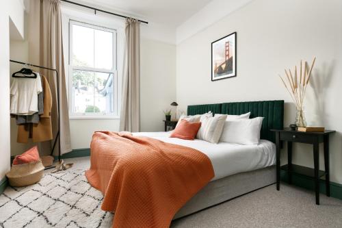 - une chambre avec un lit recouvert d'une couverture orange dans l'établissement NEW LUXURY for 2022 - Central Plymouth House - Sleeps 10 - Access to Plymouth Hoe - Close to The Barbican - Pets welcome - By Luxe Living, à Plymouth