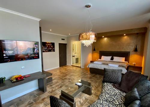 a living room with a couch and a bed at Luxury Apartments Ivon in Plovdiv