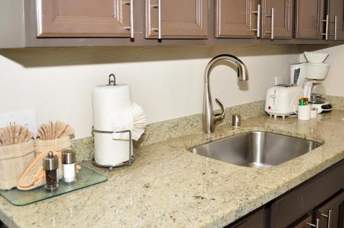 a kitchen counter top with a sink and a counter top at Laguna Shores Studio Suites in Laguna Beach