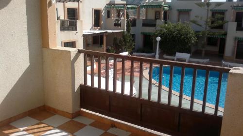 a balcony of a building with a swimming pool at Precioso apartamento costa Murciana in Puerto de Mazarrón