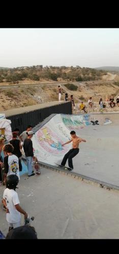 a group of people standing around a skateboard ramp at Tigmi surf morocco in Tiguemmi nʼAït Bihi