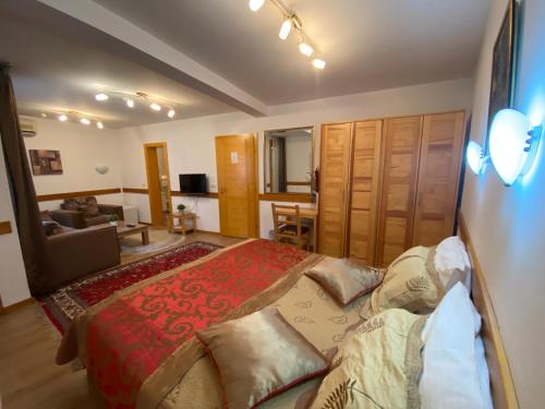 a bedroom with a large bed with pillows on it at Hotel Berr in Sarajevo