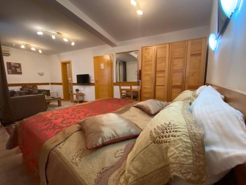 a bedroom with a bed with pillows on it at Hotel Berr in Sarajevo