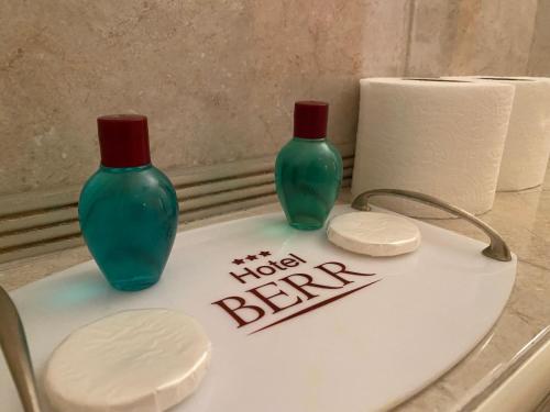two green vases sitting on top of a toilet at Hotel Berr in Sarajevo