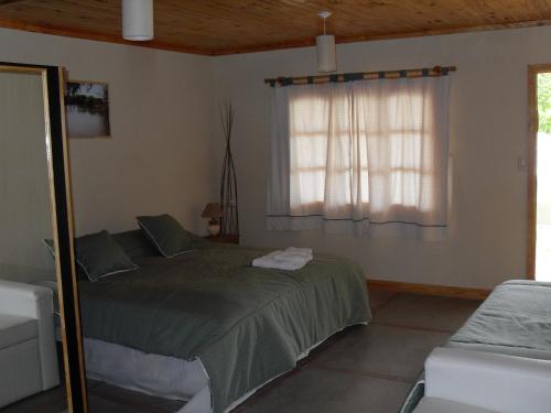 En eller flere senge i et værelse på Vistalba Lodge
