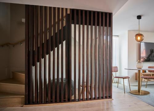 a wooden partition in a room with a table at Leven Manchester in Manchester