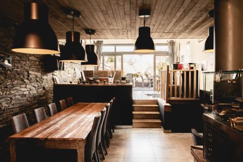 a dining room with a wooden table and chairs at Il était une fois in Herbeumont