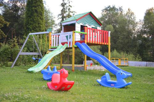 a playground with a slide in the grass at DW Paryżanka in Poronin