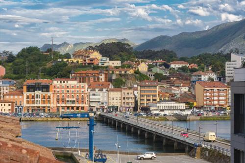 a city with a bridge over a body of water at El Pico, Apartamento in Ribadesella