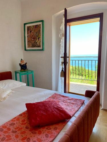 een slaapkamer met een bed en een grote glazen schuifdeur bij Vila Loralina - Izola - direct Sea view in Izola