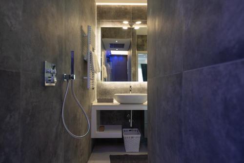 a bathroom with a sink and a mirror at Magic Luxury Apartments in Bardolino