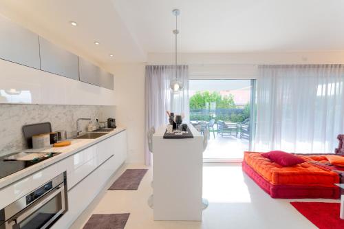 a kitchen and living room with a couch and a table at Magic Luxury Apartments in Bardolino