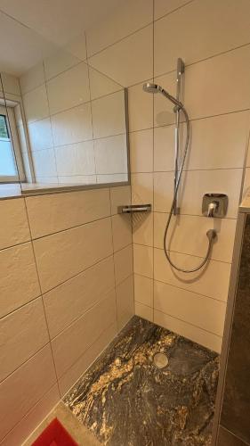 a bathroom with a shower with a glass door at Alpenresidenz M Vermietungs KG in See