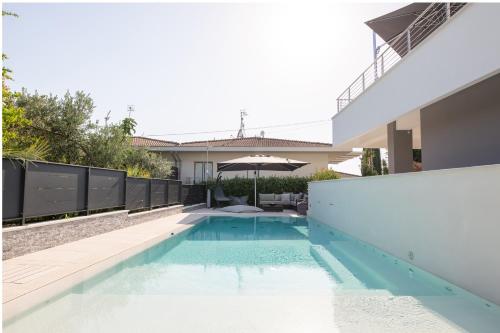 a swimming pool in the backyard of a house at Magic Luxury Apartments in Bardolino