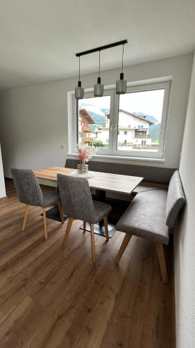 a dining room with a table and chairs and a window at Alpenresidenz M Vermietungs KG in See