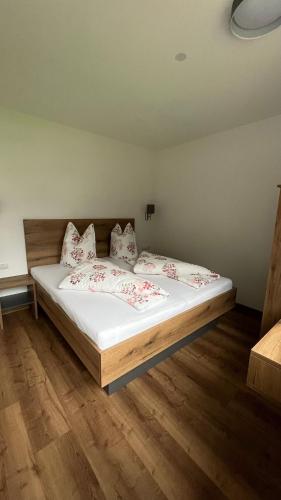 a bedroom with a bed with white sheets and pillows at Alpenresidenz M Vermietungs KG in See
