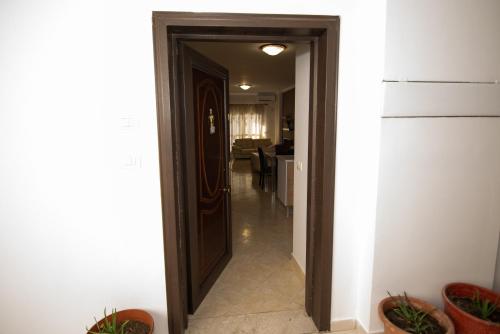 a hallway with a door leading to a living room at AMI apartament in Vlorë