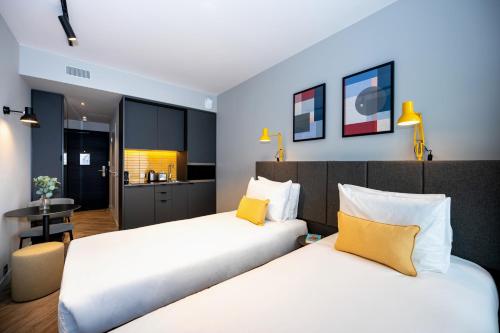 A bed or beds in a room at Staycity Aparthotels Paris La Defense