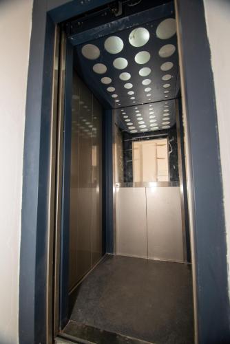 a hallway with a mirror in a building at AMI apartament in Vlorë