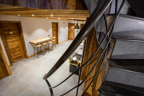 a staircase in a room with a ping pong table at Les Mazots des Fées in Morzine