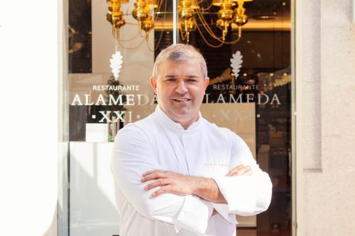 a man standing with his arms crossed in front of a store at Gran Hotel Nagari Boutique & Spa in Vigo