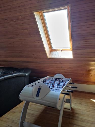 a chess board on a table in a room with a window at Vila su sauna ir kubilu gamtos apsuptyje in Kalviškiai