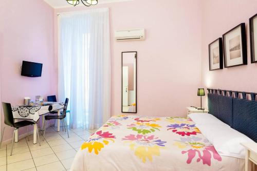 1 dormitorio con cama, mesa y escritorio en BB Augusteo, en Nápoles