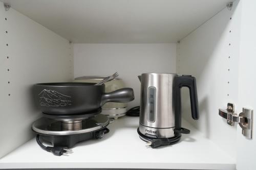 a coffee maker on a shelf in a kitchen at Haus Aida in Saas-Fee