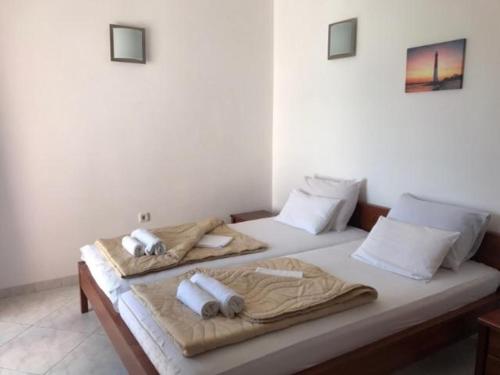 a bedroom with two beds with towels on them at Vila Tamara Apartmani in Bečići