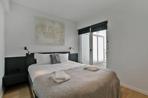 a bedroom with a large bed and a window at Top location! Unique luxurious 3-bedroom apartment in Knokke - 't Zoute in Knokke-Heist