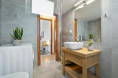 a bathroom with a white sink and a mirror at Sea,City & Mountain View Apartment in Chania Town