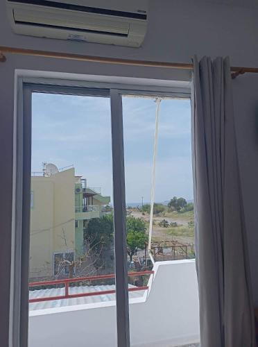 a window in a room with a view of a building at ZOGRAFOS 1 in Haraki