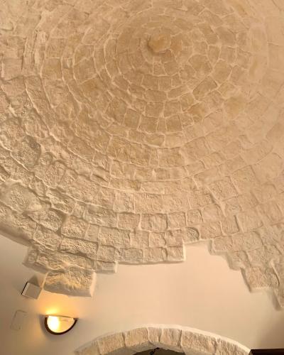 a ceiling in a room with a stone wall at IL VIGNETO SOLE&LUNA con PISCINA PRIVATA in Martina Franca