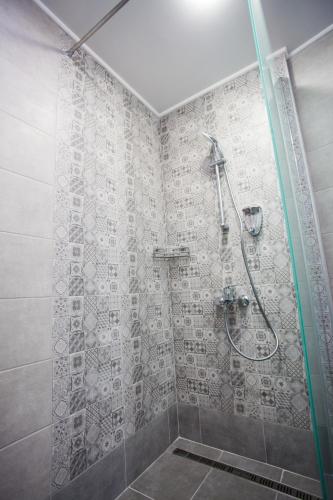 a bathroom with a shower with a glass door at Вила Чайка, Villa Chaika in Balchik