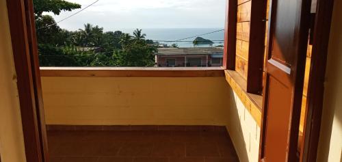 an open door to a balcony with a view of the ocean at Le Rahma in Sada