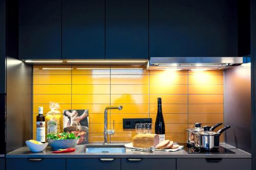 a kitchen with a sink and a counter top at Staycity Aparthotels Paris La Defense in Courbevoie
