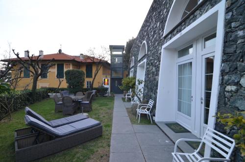 a patio with chairs and tables on the side of a building at Villa Margherita in Levanto
